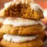 golden-brown soft pumpkin cookies with a tender, cake-like texture, arranged on a white plate with fall leaves in the background.golden-brown soft pumpkin cookies with a tender, cake-like texture, arranged on a white plate with fall leaves in the background.