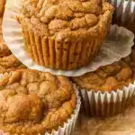 Golden brown pumpkin banana muffins with chocolate chips and cinnamon streusel topping arranged on a wire cooling rack